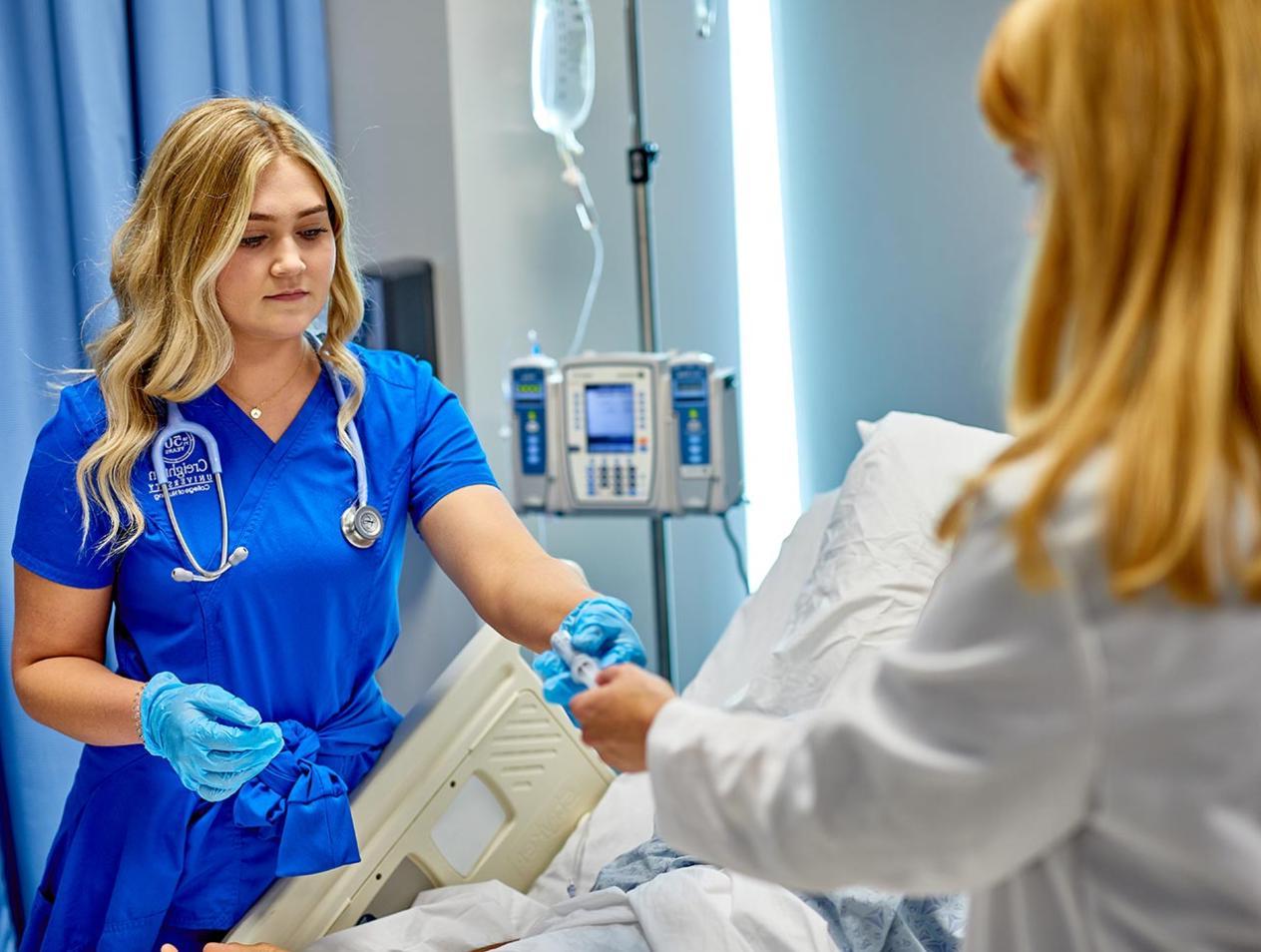 Nurse attending patient in hospital bed